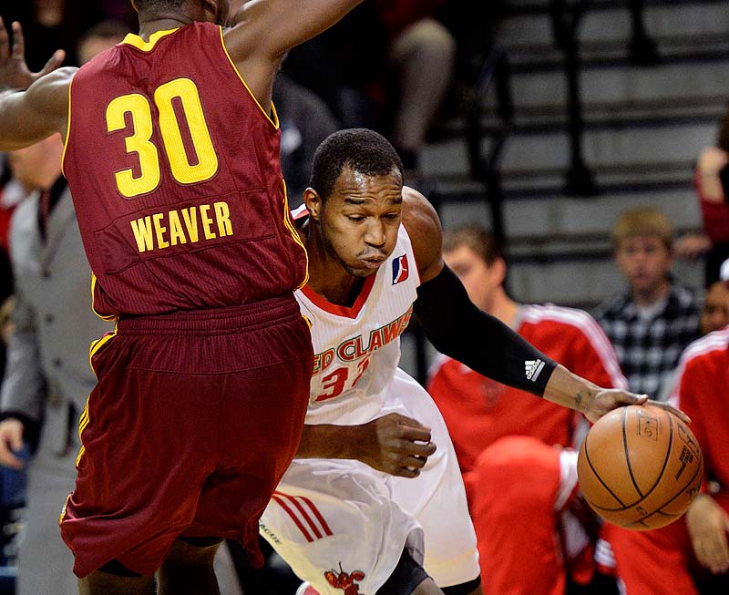 Maine's Chris Wright drives around Kyle Weaver of the Canton Charge in a March 10, 2013, game at the Portland Expo. This weekend the Red Claws can guarantee themselves a spot in the postseason.