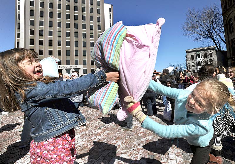 Evie King, 8, and Jocelyn Ruffner, 8, from Yarmouth take part at the International Pillow Fight Day celebrated at Monument Square in Portland last year.