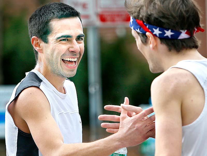 Winner Louie Luchini of Ellsworth, left, congratulates second-place finisher Chris Harmon of Scarborough after finishing the 84th Patriots Day 5-mile race in Portland on Sunday.