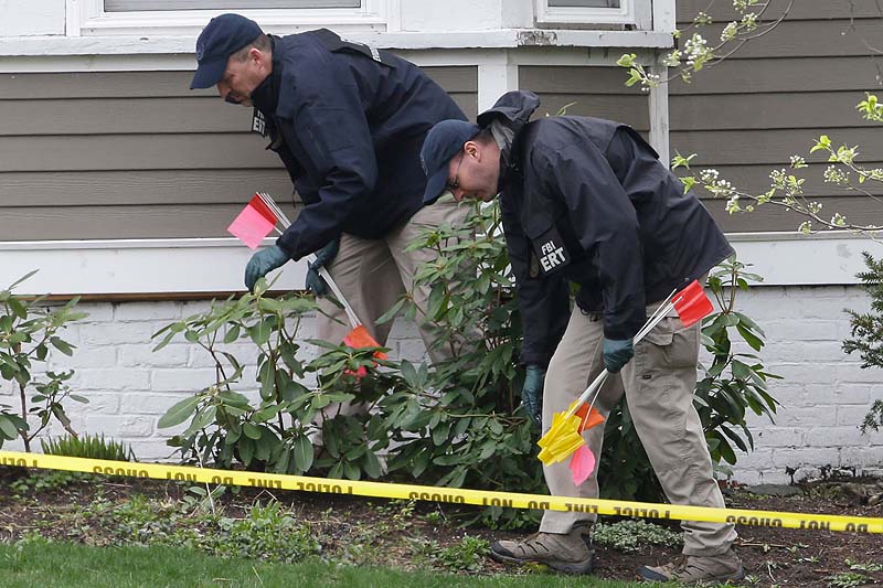 Investigators on Saturday work near the location where the previous night a suspect in the Boston Marathon bombings was arrested in Watertown, Mass.