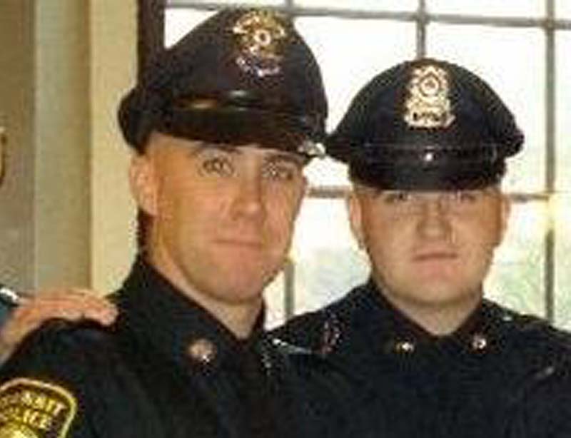 In this 2010 photo provided by the Massachusetts Bay Transportation Authority, Richard Donohue Jr., left, and Sean Collier pose together for a photo at their graduation from the Municipal Police Officers' Academy.