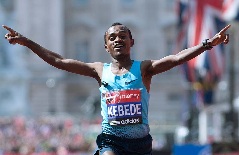 Tsegaye Kebede of Kenya puts his arms out as he celebrates after winning the men's London Marathon on Sunday,