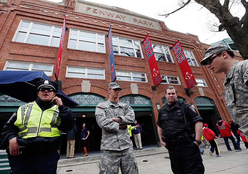 Police and National Guard soldiers stand outside Fenway Park before Boston's game Saturday against the Kansas City Royals.
