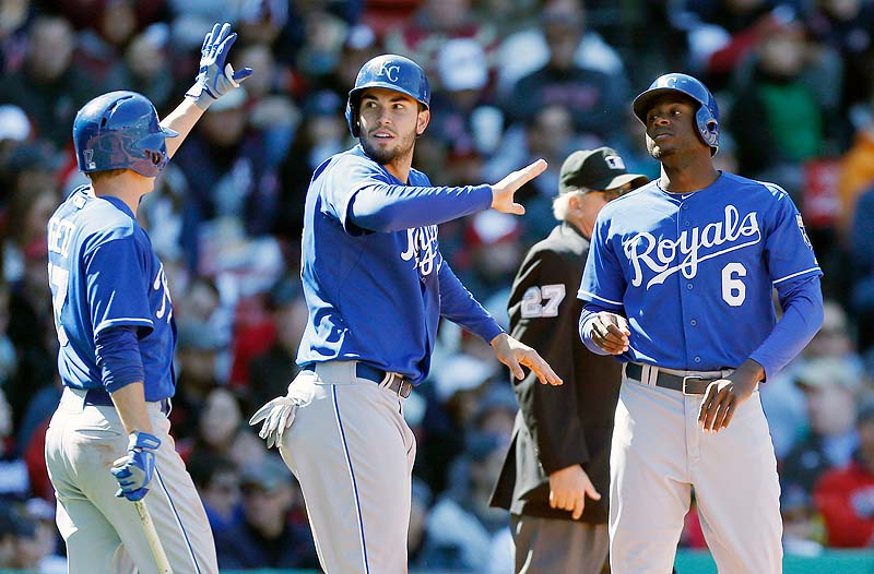 Kansas City's Chris Getz, left, celebrates after Eric Hosmer, center, and Lorenzo Cain score on a single by Salvador Perez in the fourth inning Sunday against the Red Sox at Fenway Park in the first game of a doubleheader.