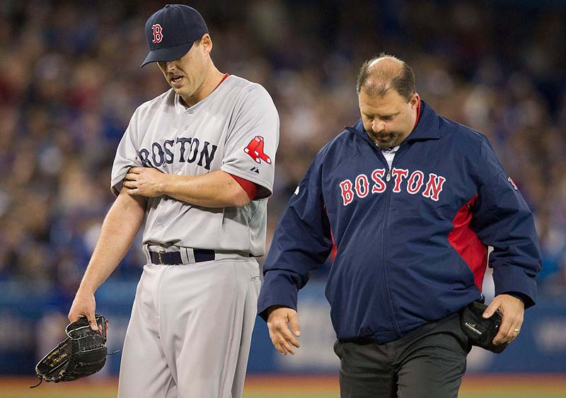 John Lackey walks off the field with trainer Rick Jameyson after he was injured in the fifth inning Saturday at Toronto. Lackey suffered a right biceps strain. Blue Jays;athlete;athletes;athletic;athletics;Canada;Canadian;Ce