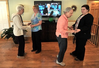 Martha Fabian, far left, dances with Debi Braun alongside June Meres and Maribeth Beland, far right, in the day room at Bedside Manor on Belgrade Road in Oakland. Fabian and Meres are residents at the 10-bed Alzheimer’s care facility operated by Fabian’s son, E.J. Fabian, and her daughter, Julie Benecke.