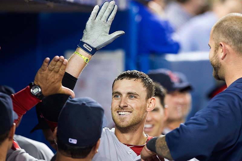 Will Middlebrooks celebrates in the dugout after hitting his third home run Sunday against the Blue Jays in Toronto. Boston won 13-0.