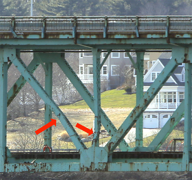 Red arrows point to two of bent supports that run between the lower railroad deck and the upper roadway deck of the Sarah Mildred Long Bridge. The supports were damaged when the tanker Harbour Feature hit the bridge on Monday.