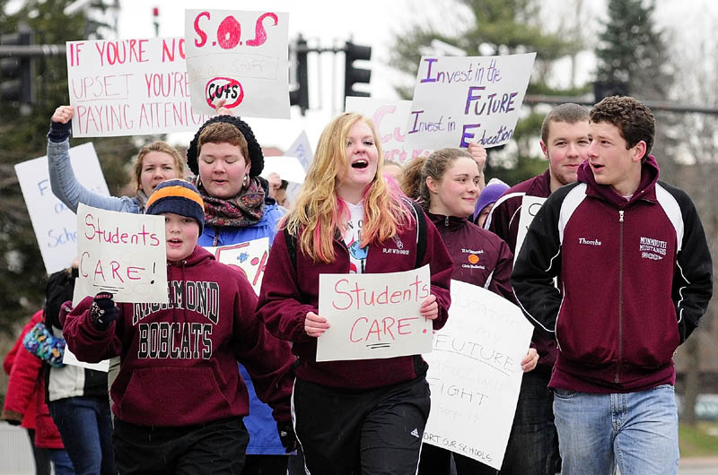 Students march along State Street in front of the State House during a protest on Friday at the State House in Augusta.