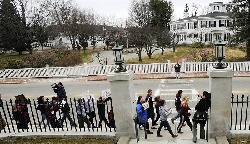 Students march along Capital Street between State House and Blaine House during a protest on Friday in Augusta.