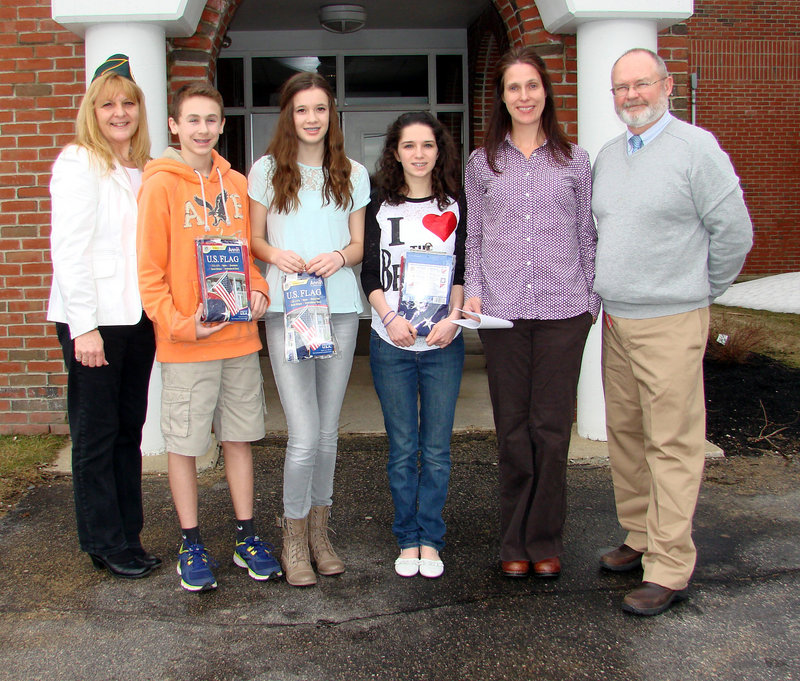 Three Wells Junior High students were cited for their entries in an Americanism essay contest. From left, Deb Coady of the Amvets, students Wesley Moody, Kayla Looper and Emily Cottis, their teacher Julie Esch and Principal Chris Chessie.