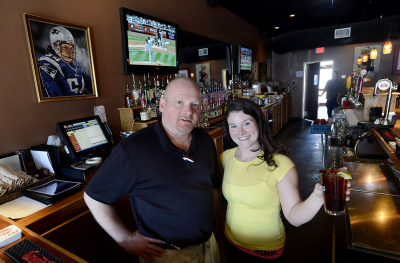 Mike Corey and Amy King are part of the staff at JP Thornton’s Bar & Grille on Broadway in South Portland, where people gather after work and pictures of New England athletes adorn the walls.