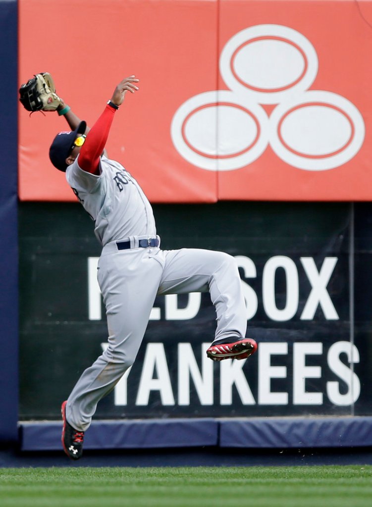 Jackie Bradley Jr. makes an acrobatic catch on Robinson Cano's deep drive to left field in the third inning at Yankee Stadium.