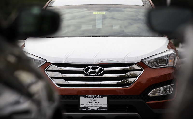 A Hyundai Sonata is seen outside a Hyundai car dealership last October in Des Plaines, Ill. For nearly two decades, the Toyota Camry and the Honda Accord have ruled the midsized car market. But now the dominance is starting to slip.