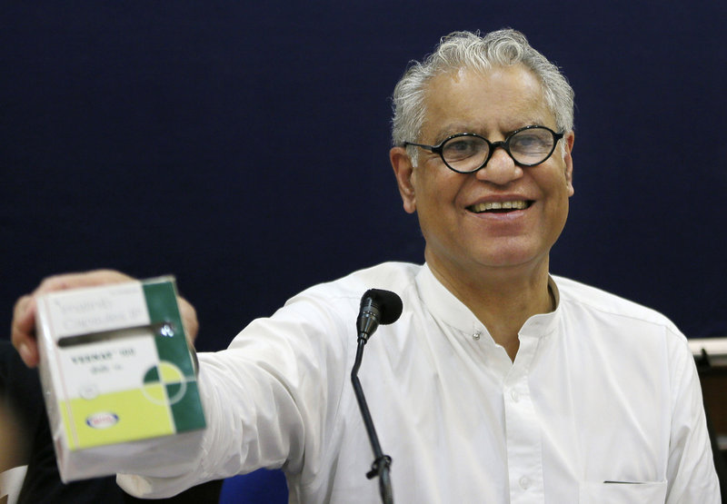 Anand Grover, attorney for the Cancer Patients Aid Association, shows the package of an Indian-made cancer drug costing $175 per month as compared to Novartis’ $2,600.