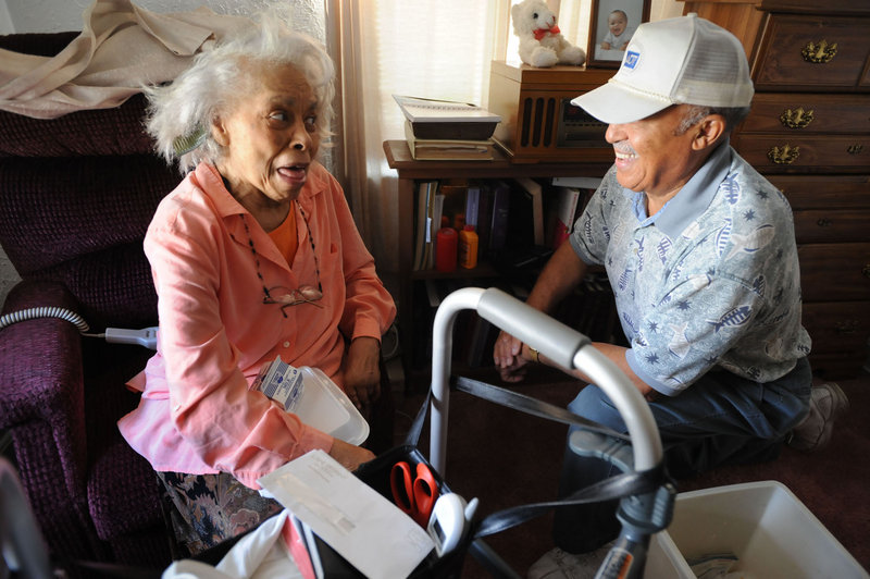 A Meals on Wheels client in Charleston, W.Va., visits with the man who delivered her meal, in 2008. A volunteer with the program in Brunswick says sequester-related funding cutbacks will affect the frequency of meal deliveries and well-being checks.