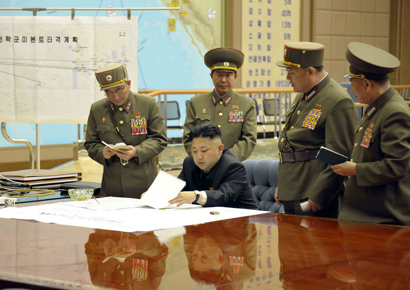 Kim Jong Un, center, presides over an operation meeting at the Supreme Command in Pyongyang, North Korea, on March 29. Analysts say Un could be trying to appease military hard-liners in his country by threatening the United States.