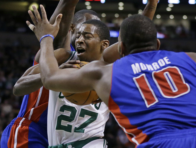 Boston’s Jordan Crawford drives between two Detroit defenders in the Celtics’ 98-93 win Wednesday at Boston.