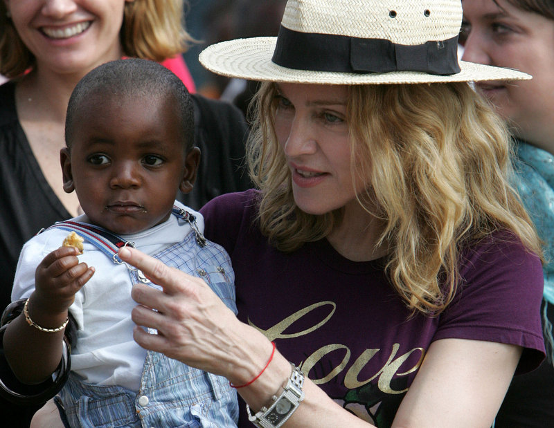 Pop singer Madonna carries her son, David Banda, in April 2007 while visiting Malawi. She has adopted two children from the country.