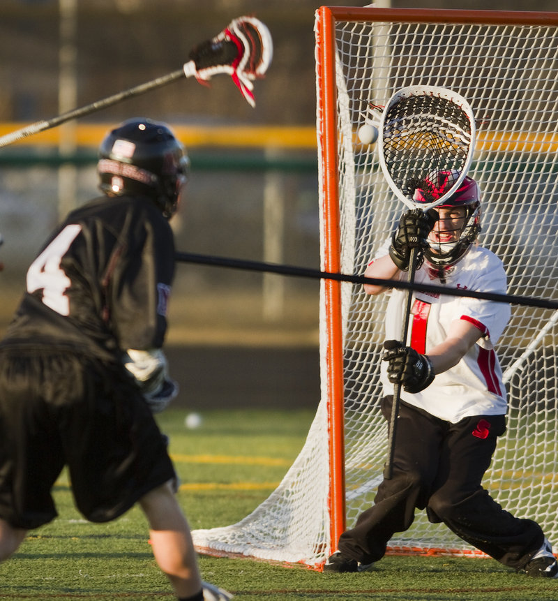 Scarborough goalie David Pearson keeps his eye on a shot Thursday during a lacrosse scrimmage against Mercer Island, Wash. Mercer Island has traveled on spring break for 11 of the past 12 years in search of quality competition.