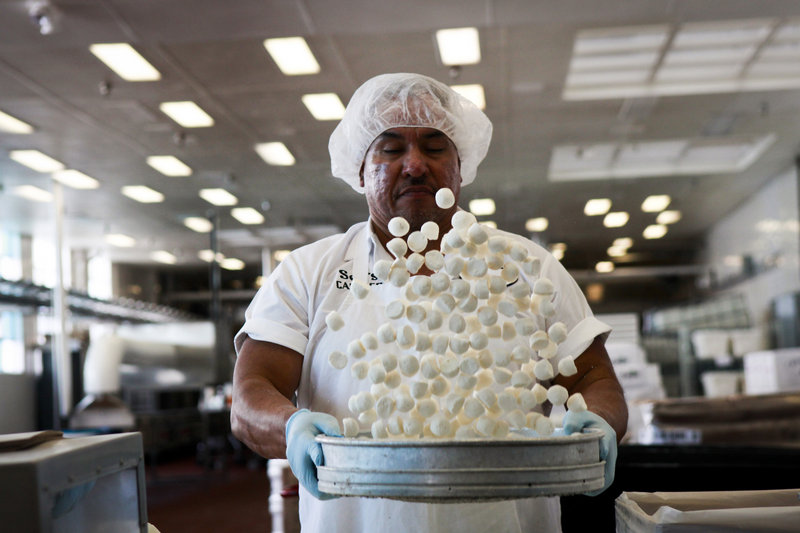 Arturo Barboza tosses house-made honey marshmallows, the start of See’s Candies’ Rocky Road Eggs.