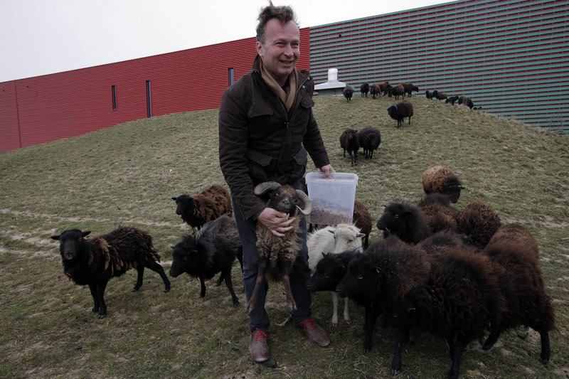 Sylvain Girard, owner of “Ecomouton,” shows his flock used to graze the lawns around a truck warehouse at Evry, south of Paris. Paris is enlisting the help of a small flock of sheep to keep the city’s grass trim.