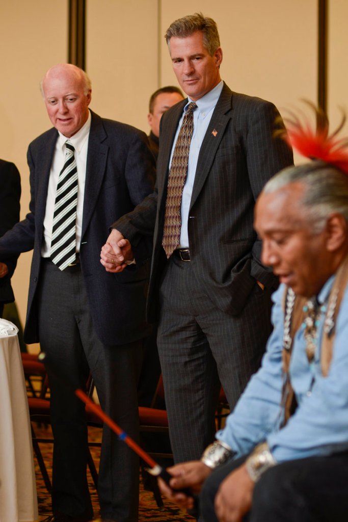 Former U.S. Sen. Scott Brown of Massachusetts watches a traditional drum ritual of the Pequot tribe during the 11th Annual "Keeping the Dream Alive" dinner commemorating the anniversary of Martin Luther King Jr.'s death, Thursday, April 4, 2013 in Nashua, N.H. Declaring that he's likely not done with politics, former U.S. Sen. Scott Brown from Massachusetts refused Thursday to rule out a run for office in New Hampshire, while describing the Granite State as "almost a second home." (AP Photo/The Telegraph, Will Wrobel)
