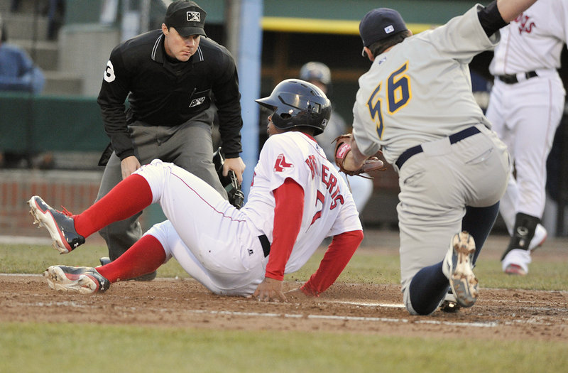 Xander Bogaerts of the Portland Sea Dogs slides across the plate Friday night, scoring on a wild pitch as Trenton pitcher Zach Nuding covers during Portland’s 7-4 victory at Hadlock Field. The plate umpire is Nick Mahrley.