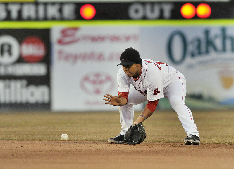 Second baseman Heiker Meneses of the Portland Sea Dogs gets low Friday night to field a grounder during the fourth inning of the game against the Trenton Thunder at Hadlock Field. The Sea Dogs won, 7-4.