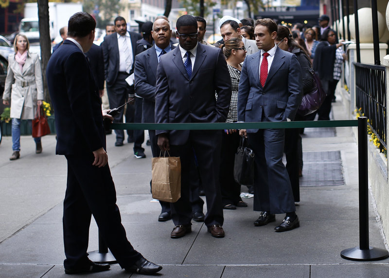 Job seekers wait to meet with prospective employers at a career fair in New York City last October. The percentage of working-age adults in the U.S. labor force – the participation rate – fell to 63.3 percent last month, the lowest such figure since 1979.