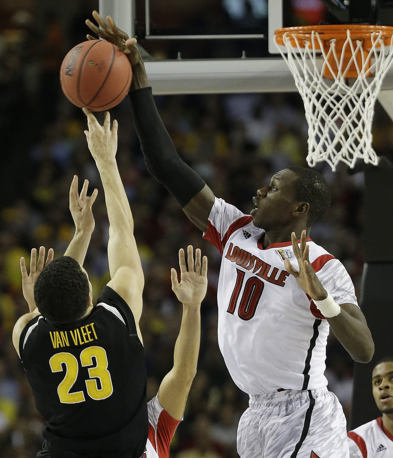 Gorgui Dieng of Louisville knocks away a shot by Fred Van Vleet of Wichita State during Louisville’s come-from-behind 72-68 victory Saturday night in the national semifinals.