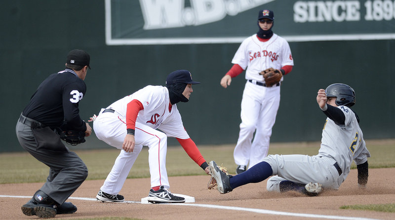 Portland’s Kolbrin Vitek puts a textbook tag on Trenton’s Tyler Austin at third base, as Austin was called out trying to advance during Trenton’s 9-7 win at Hadlock Field on Sunday.