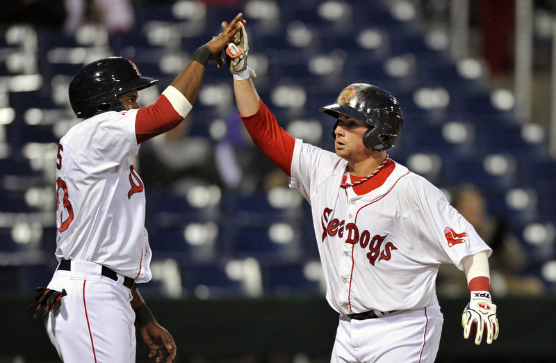Christian Vazquez of the Sea Dogs, right, is welcomed by teammate Tony Thomas after hitting a three-run homer in the sixth inning.