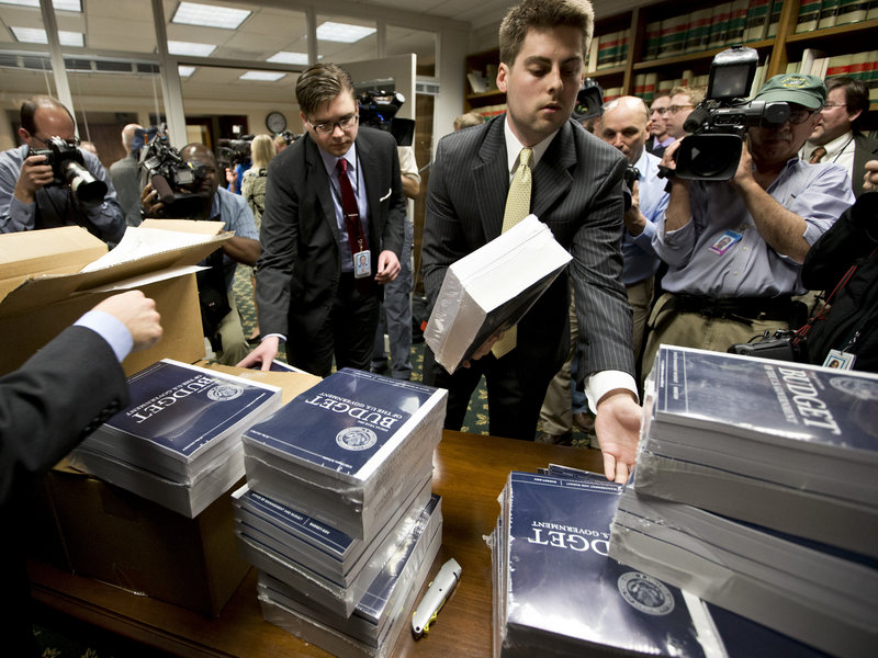 Copies of President Obama’s budget plan for fiscal year 2014 are distributed to Senate staff on Capitol Hill in Washington on Wednesday.