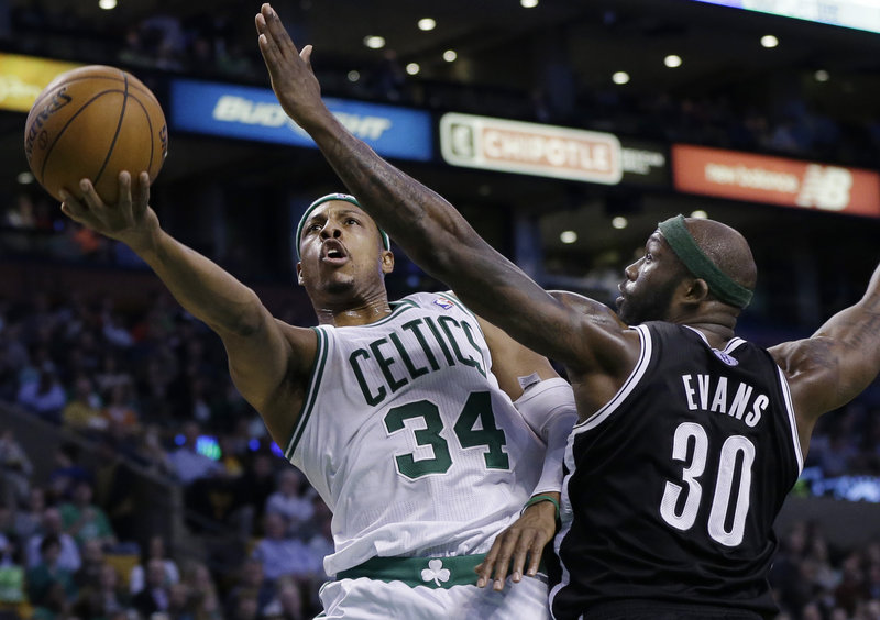 Paul Pierce, who scored a team-high 23 points Wednesday night for the Boston Celtics, drives past Reggie Evans of the Brooklyn Nets for a layup during the Nets’ 101-93 victory at Boston.