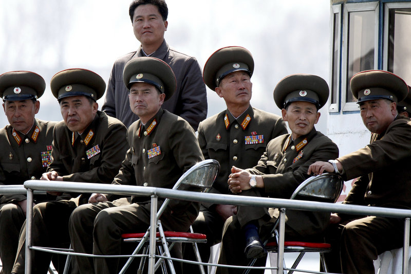 North Korean military officers ride on a sight-seeing boat on the Yalu River on the China-North Korea border on Wednesday.