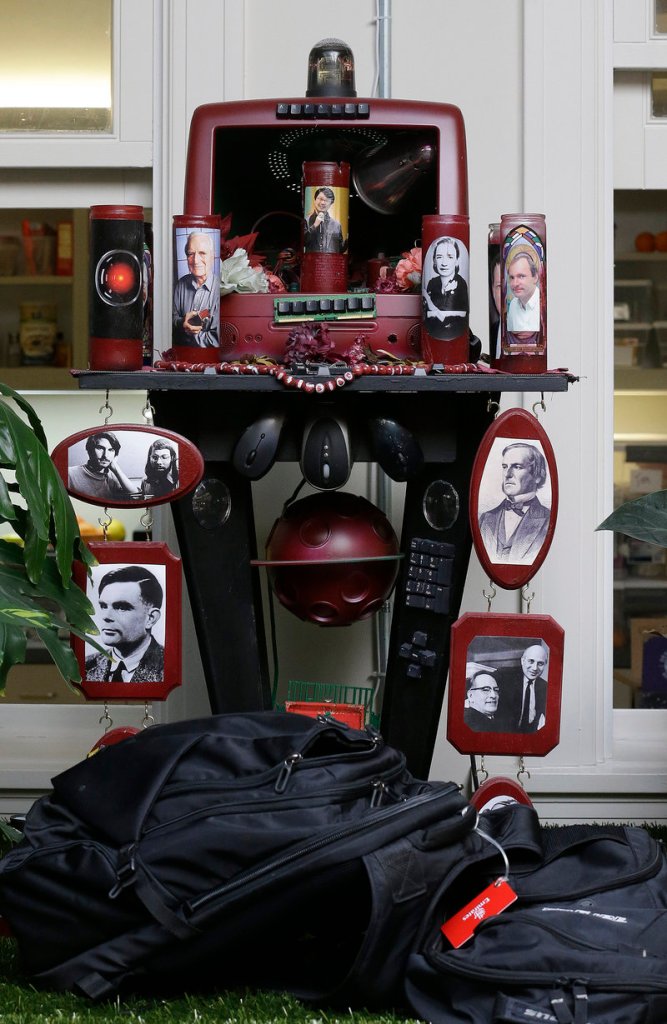 A shrine with photos of Steve Jobs, Steve Wozniak, Craig Barrett and others is shown at the Dev Bootcamp office in San Francisco.