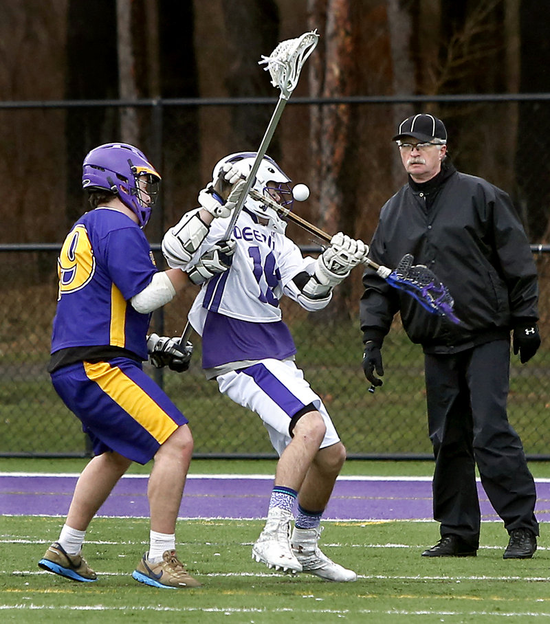 Alec Halpin, right, of Deering receives a close look at the ball as Mina Para of Cheverus defends in the second quarter. Halpin finished with three goals for the Rams.