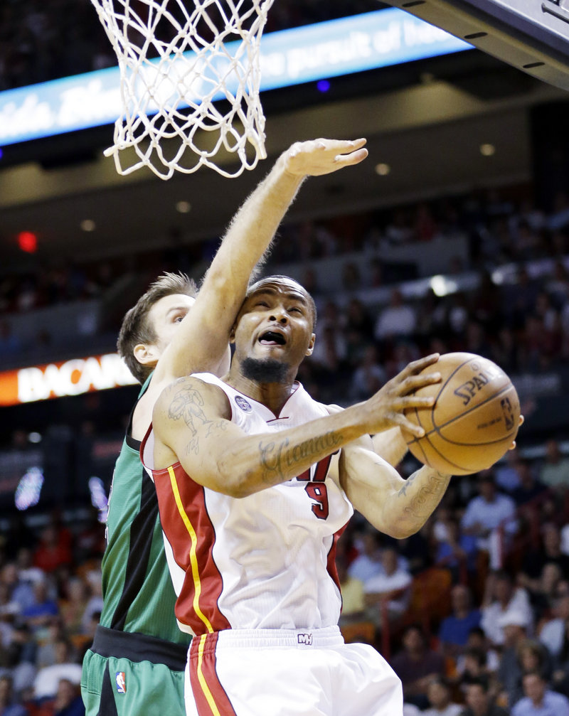 Miami Heat forward Rashard Lewis goes up for a shot against Boston Celtics forward Shavlik Randolph during the first half Friday in Miami. The Heat scored 41 points in the second quarter on the way to a 109-101 win.