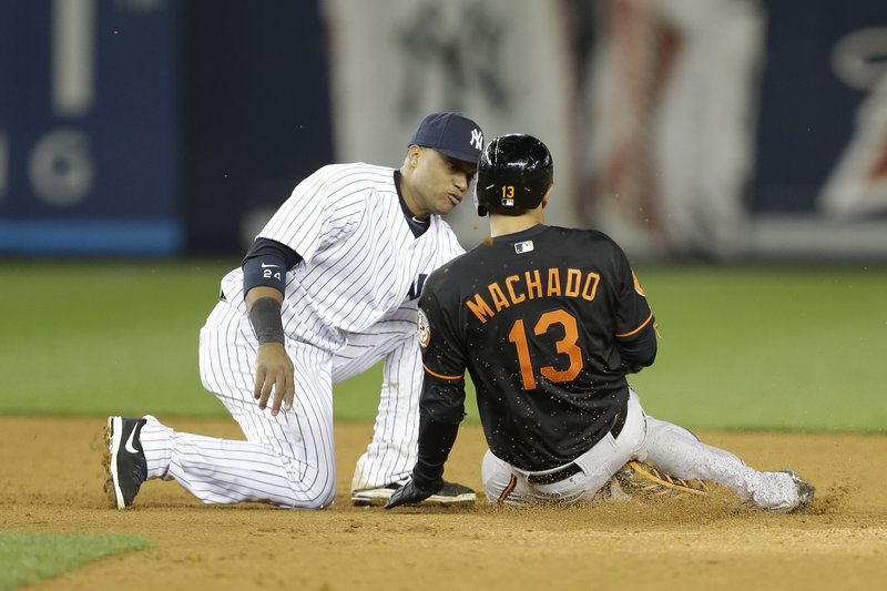 Yankees second baseman Robinson Cano tags out Manny Machado of the Orioles to complete a triple play in the eighth inning of New York’s 5-2 win Friday night at Yankee Stadium.