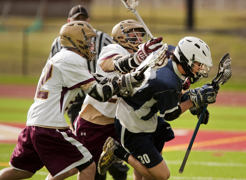 Christian Michaud, left, and Zachary Bryant of Thornton Academy put pressure on Ben Allen of Portland during their schoolboy lacrosse opener Saturday. Thornton won, 9-4.