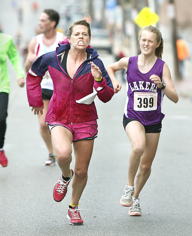 Competition is keen at the finish as Laura Johnson, left, of Portland edges Anne McKee, 14, of Hallowell for second place in the women’s division.