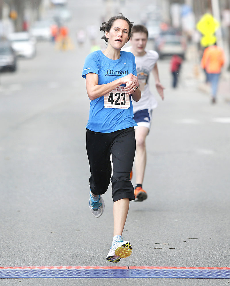 Women’s winner Meredith Anderson of Portland crosses the finish line during the 84th Boys and Girls Club Patriots Day 5-mile road race in Portland on Sunday. Ellsworth native Louie Luchini was the men’s winner.