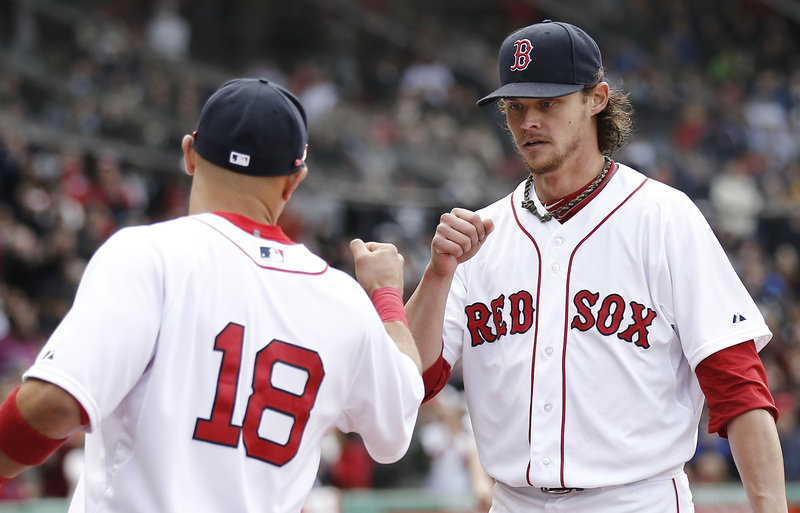 Boston Red Sox starting pitcher Clay Buchholz fist bumps with Shane Victorino after the eighth inning, when he lost his bid for a no-hitter. Buchholz struck out 11 and allowed two hits in eight innings.