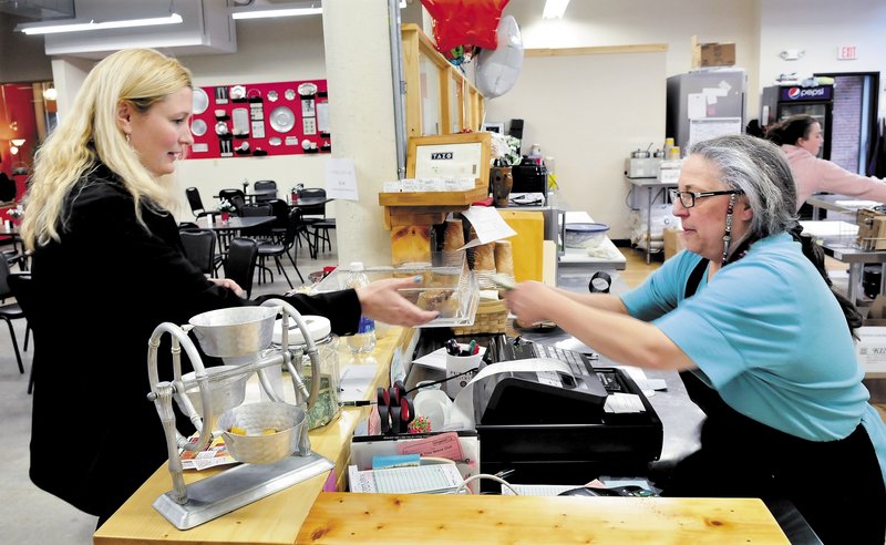 The Button-Down Cafe owner Maureen Kibler, right, gives change to customer Sarah Brown at the new restaurant in the Hathaway Creative Center in Waterville. The Button-Down Cafe is one of three new downtown eateries livening up the scene in Waterville.