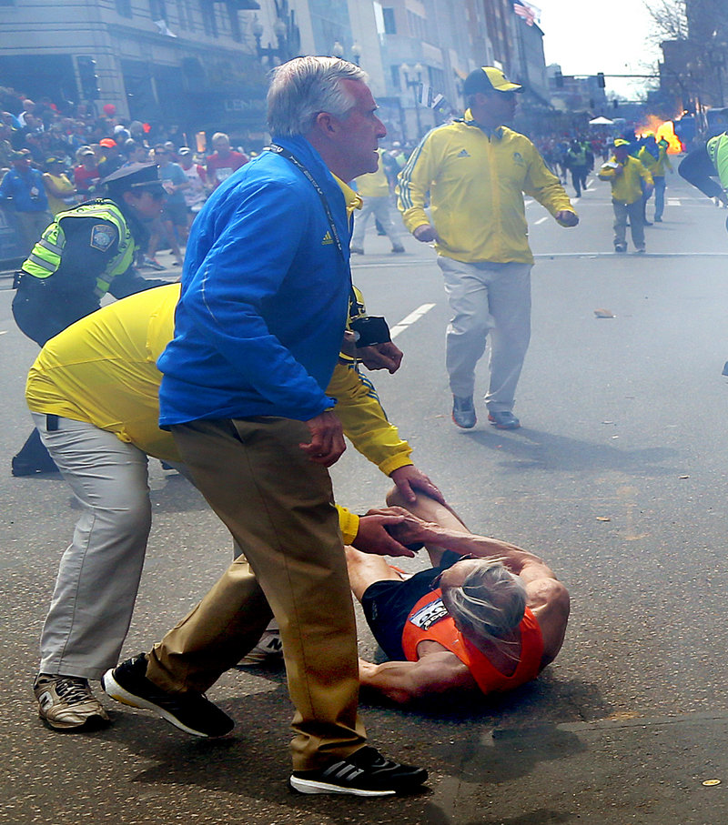 People react to the second explosion near the finish line of the Boston Marathon Monday.