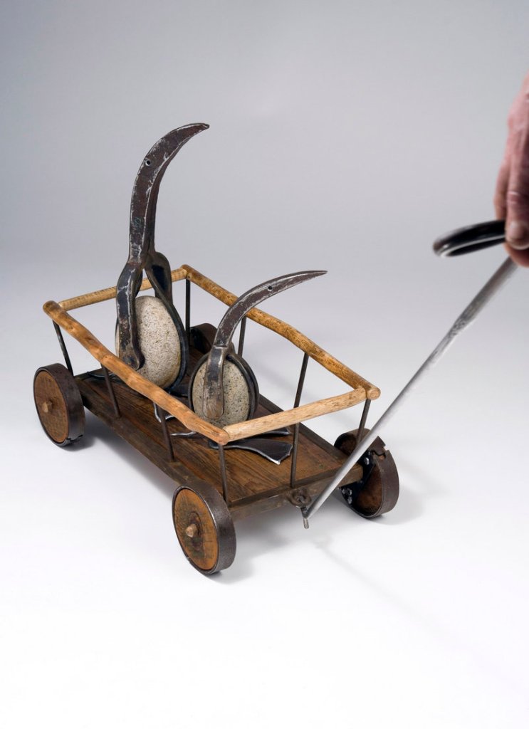 Patrick Plourde's "Penguins in Hay Wagon Pull Toy," 2013, vintage tools, steel, stones, wood.