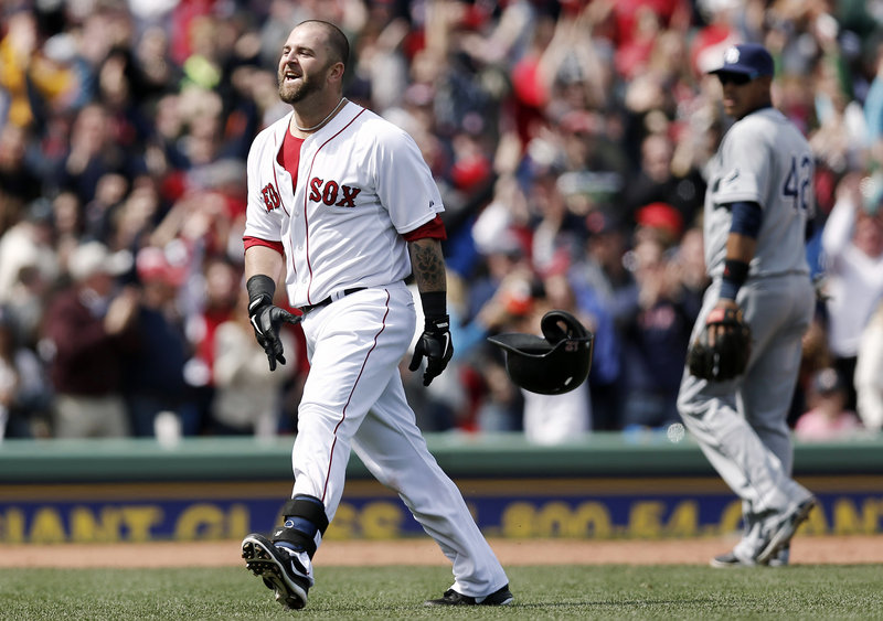 Boston’s Mike Napoli celebrates after his ninth-inning double brought home Dustin Pedroia with the winning run Monday afternoon during the annual Patriots Day game at Fenway Park.