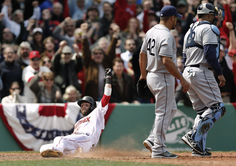 Dustin Pedroia slides home with the winning run on a double by teammate Mike Napoli as Tampa Bay pitcher Joel Peralta and catcher Jose Lobaton walk away.