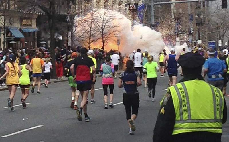 Runners approach the finish line of the Boston Marathon just as an explosion erupts Monday, one of two that took place about 10 seconds and about 100 yards apart. The blasts knocked spectators and at least one runner off their feet, shattered windows and sent dense plumes of smoke rising over the street. As many as two unexploded bombs also were found near the end of the 26.2-mile course as part of what appeared to be a well-coordinated attack, but they were safely disarmed, said a senior U.S. intelligence official.